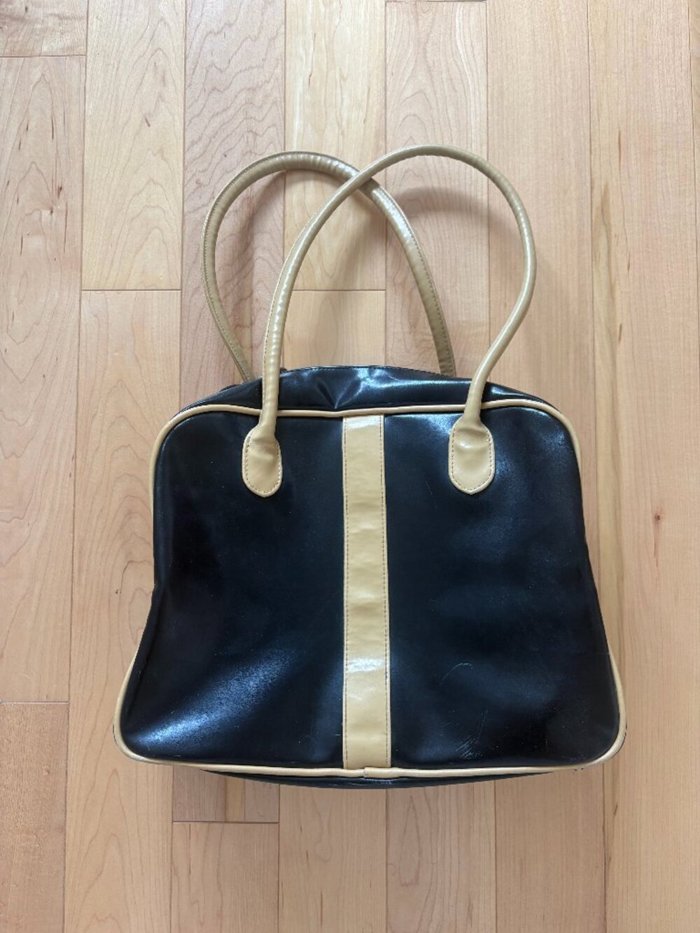 black leather bowler bag with yellow stripe